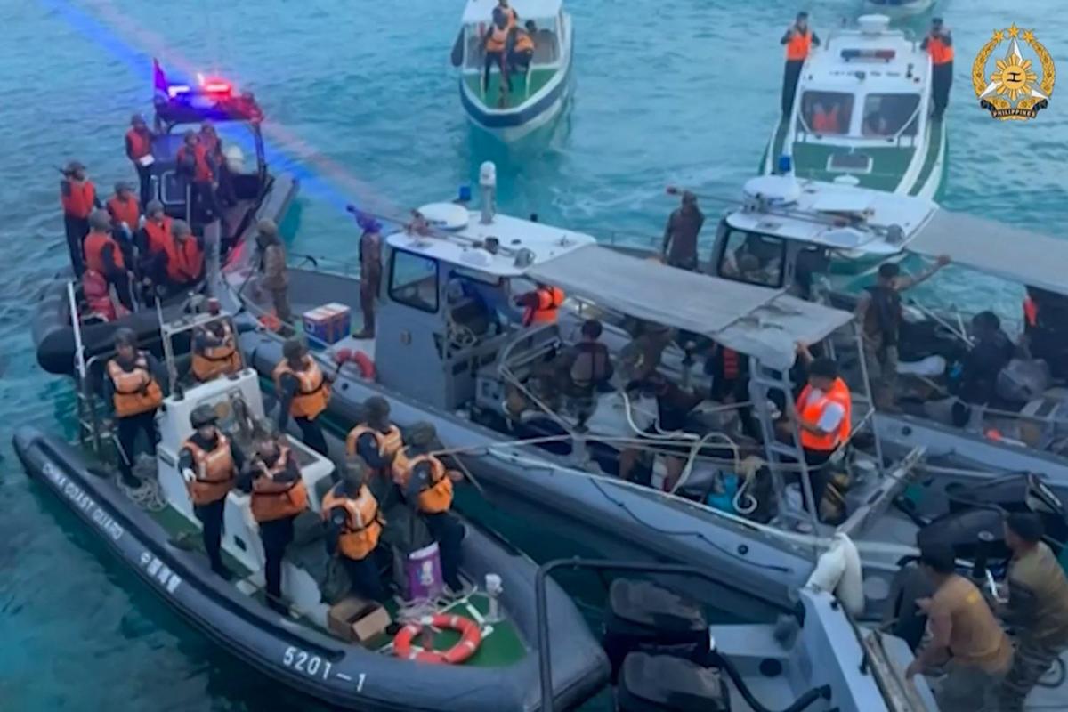 This frame grab from video taken on June 17, 2024 and released by the Armed Forces of the Philippines Public Affairs Office on June 19 shows Chinese coast guard ships (L) approaching Philippine ships (C) during an incident off Second Thomas Shoal in the South China Sea.  The Philippine military said on June 19 that the Chinese coast guard rammed and boarded Philippine navy ships in a violent clash in the South China Sea this week in which a Filipino sailor lost a thumb.  China defended its actions and its Foreign Ministry said on Wednesday that “no direct measures were taken” against the Filipino personnel. 