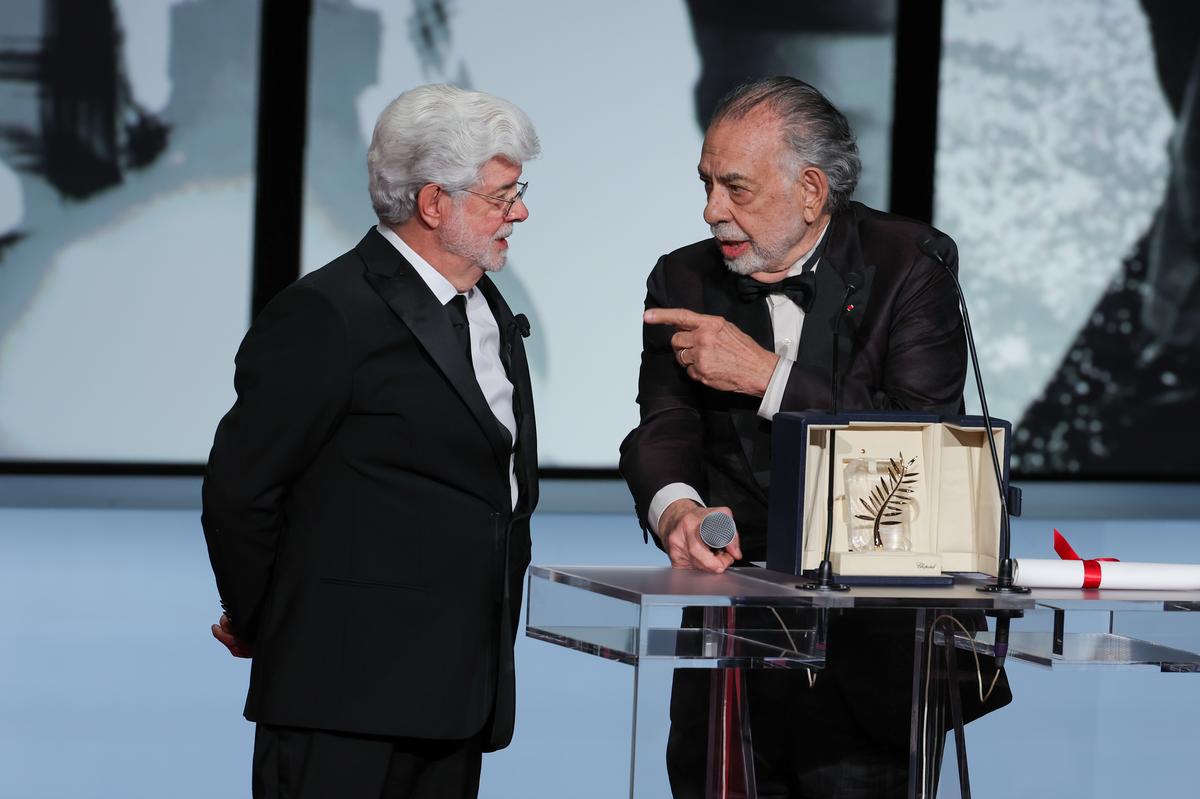 George Lucas (L) receives the Honorary Palme D’Or Award presented by Francis Ford Coppola (R) during the Closing Ceremony at the 77th annual Cannes Film Festival at Palais des Festivals on May 25, 2024 in Cannes, France.