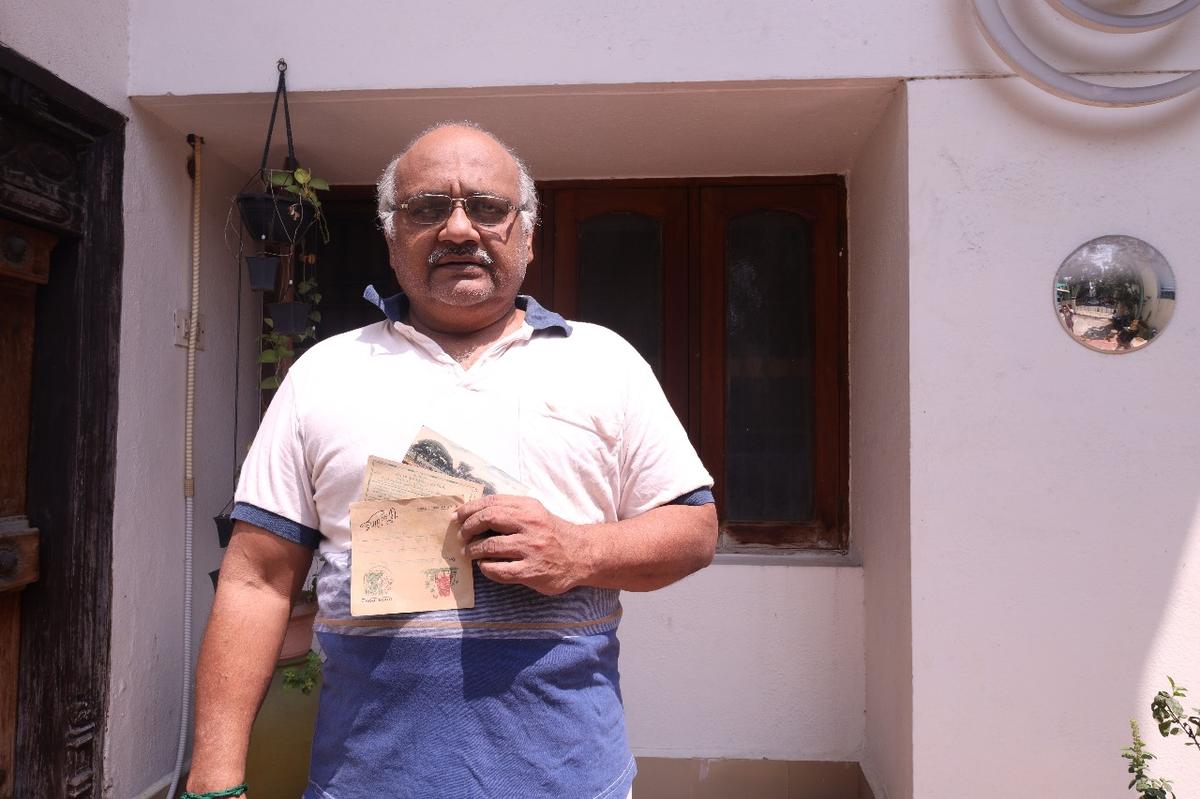 Prabhakar V with two old wedding invites both printed on postcards. Prabhakar V with two old wedding invites both printed on postcards.