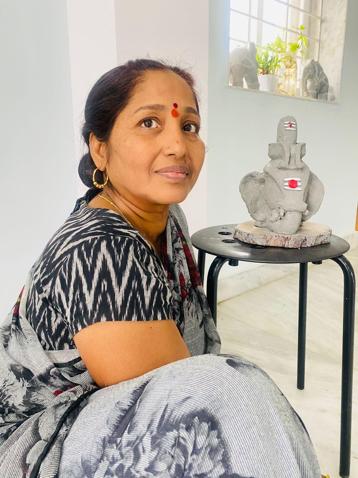 Artist Saraswathi with the clay Ganesha she created at home