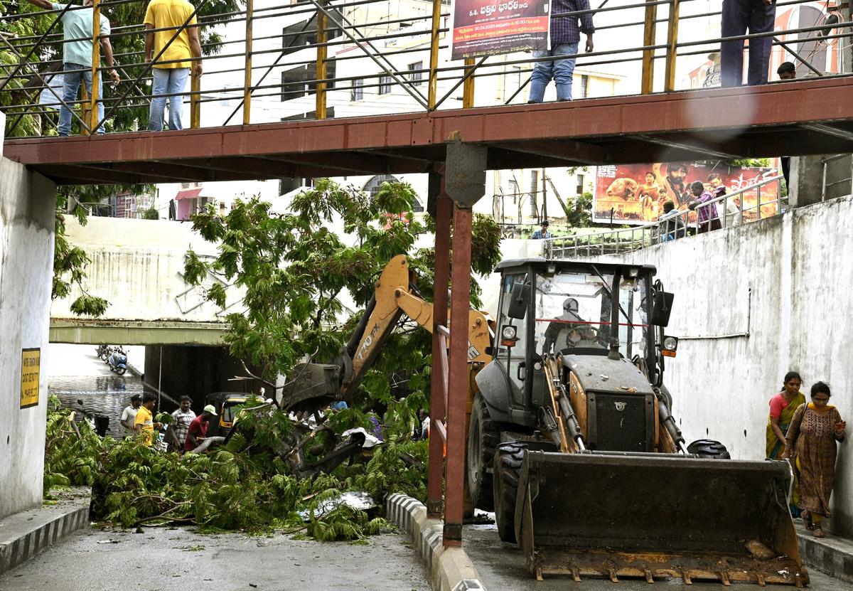 Officials having the collapsed branches of a tree removed from the Railway Under Bridge at Rayalacheruvu Road in Tirupati on Sunday.