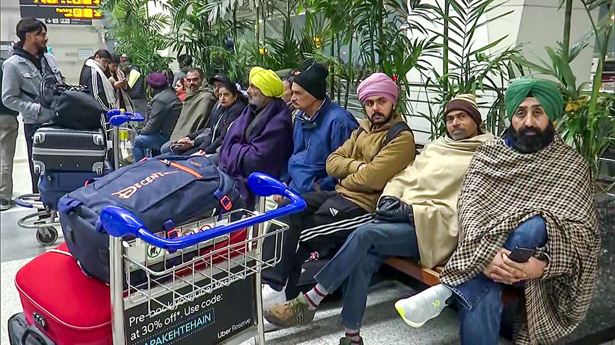 Passengers await at the Indira Gandhi International Airport in New Delhi on a cold winter morning. Several flights get delayed and a few get cancelled due to fog in several parts of the country. 