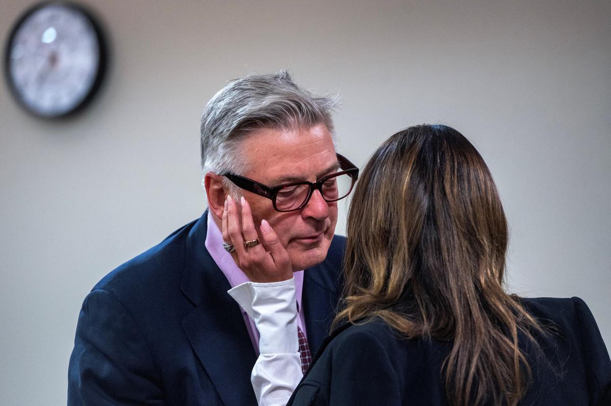 Actor and producer Alec Baldwin talks with his wife Hilaria Baldwin in First District Court during the first day of testimony in the case against him, in Santa Fe, N.M. Wednesday, July 10, 2024.