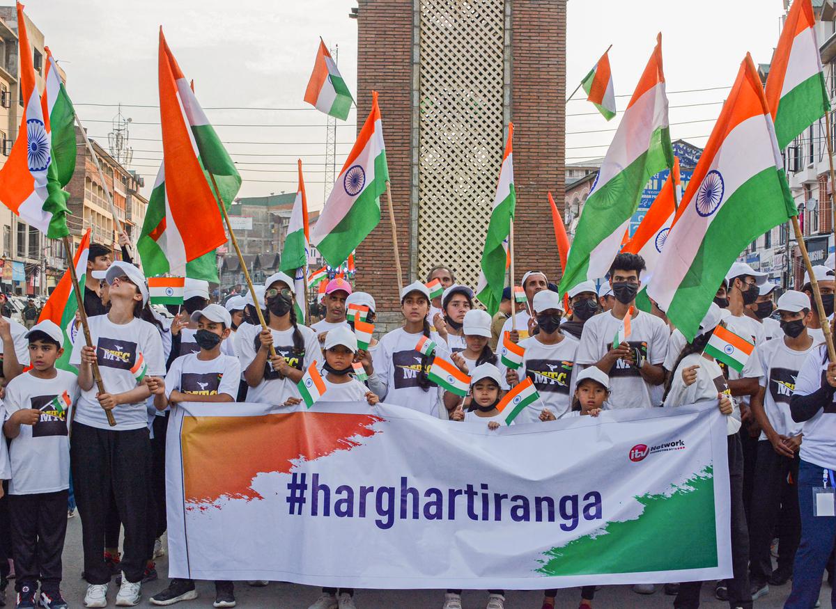 Participants of Har Ghar Tiranga rally from Kashmir to New Delhi hold the tricolour during the celebration of the abrogation of Article 35A and 370 on its third anniversary, at the historic Ghanta Ghar Lal Chowk in Srinagar.