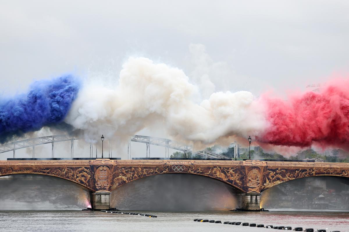 Smoke resembling the flag of Team France is shown over Austerlitz Bridge during the opening ceremony of the Olympic Games Paris 2024 on July 26, 2024 in Paris, France.