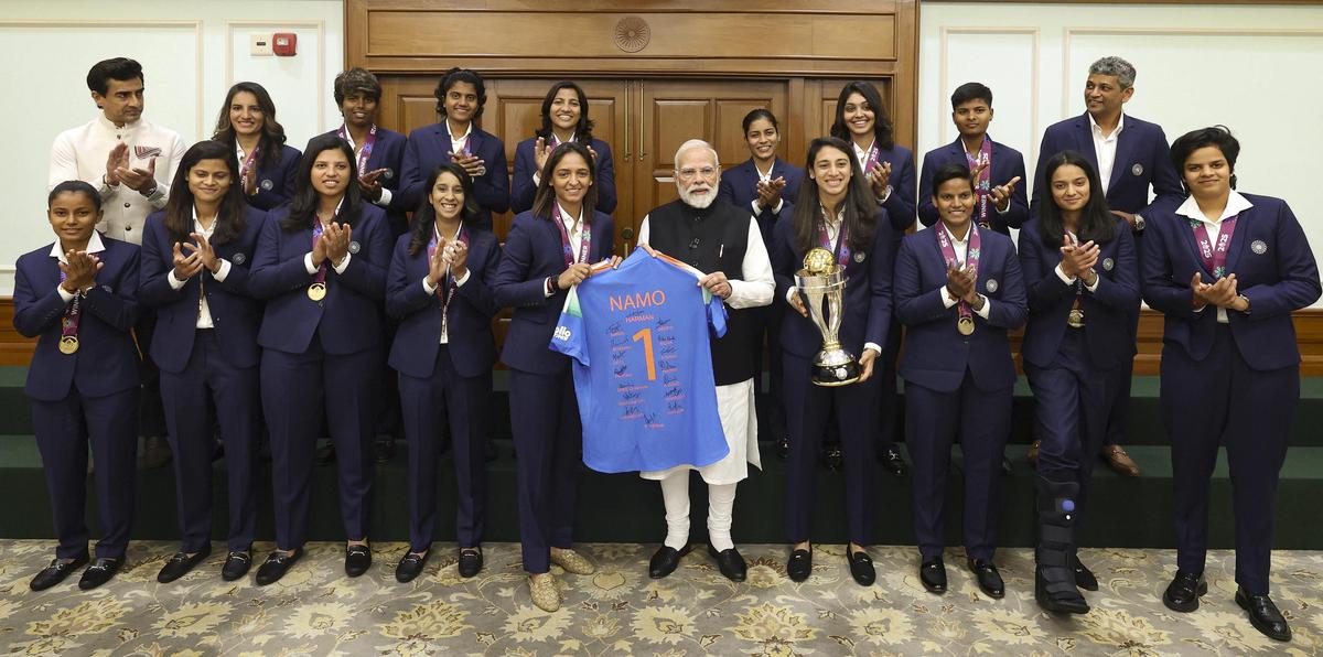 Prime Minister Narendra Modi holds a jersey with captain Harmanpreet Kaur as he poses for a photograph with the Indian women's cricket team, in New Delhi Prime Minister Narendra Modi holds a jersey with captain Harmanpreet Kaur as he poses for a photograph with the Indian women's cricket team, in New Delhi