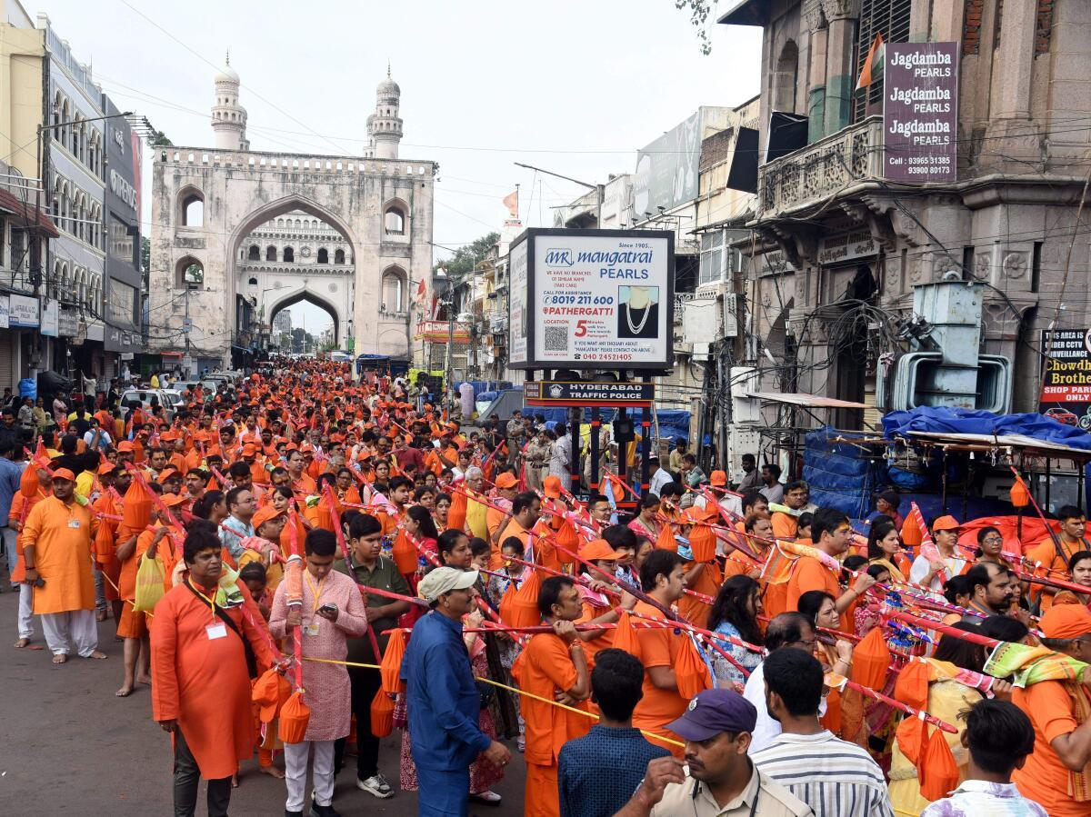 ‘Kanwariyas‘ (Lord Shiva devotees) during ‘Kawad Yatra’ in the holy month of ‘Shravan’, near Charminar, in Hyderabad, Sunday, on August 4, 2024. 