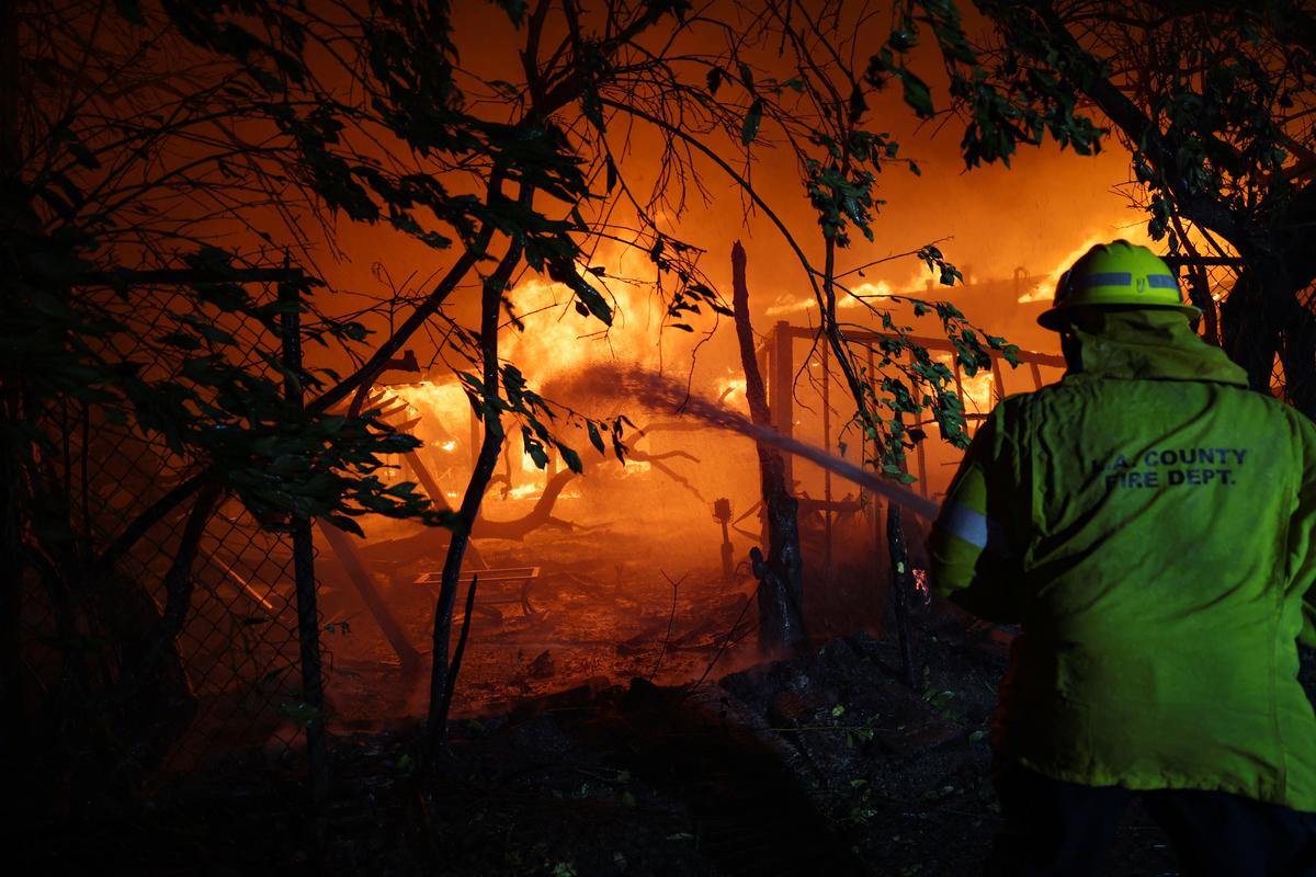 A firefighter works to extinguish flames as the Eaton Fire burns in Pasadena, California, U.S. on January 7, 2025.