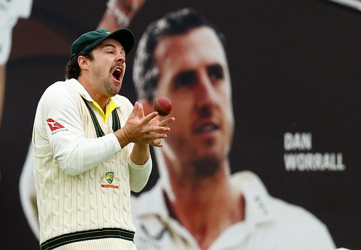 Australia’s Travis Head takes a catch to dismiss England’s Chris Woakes off the bowling of Australia’s Mitchell Starc.
