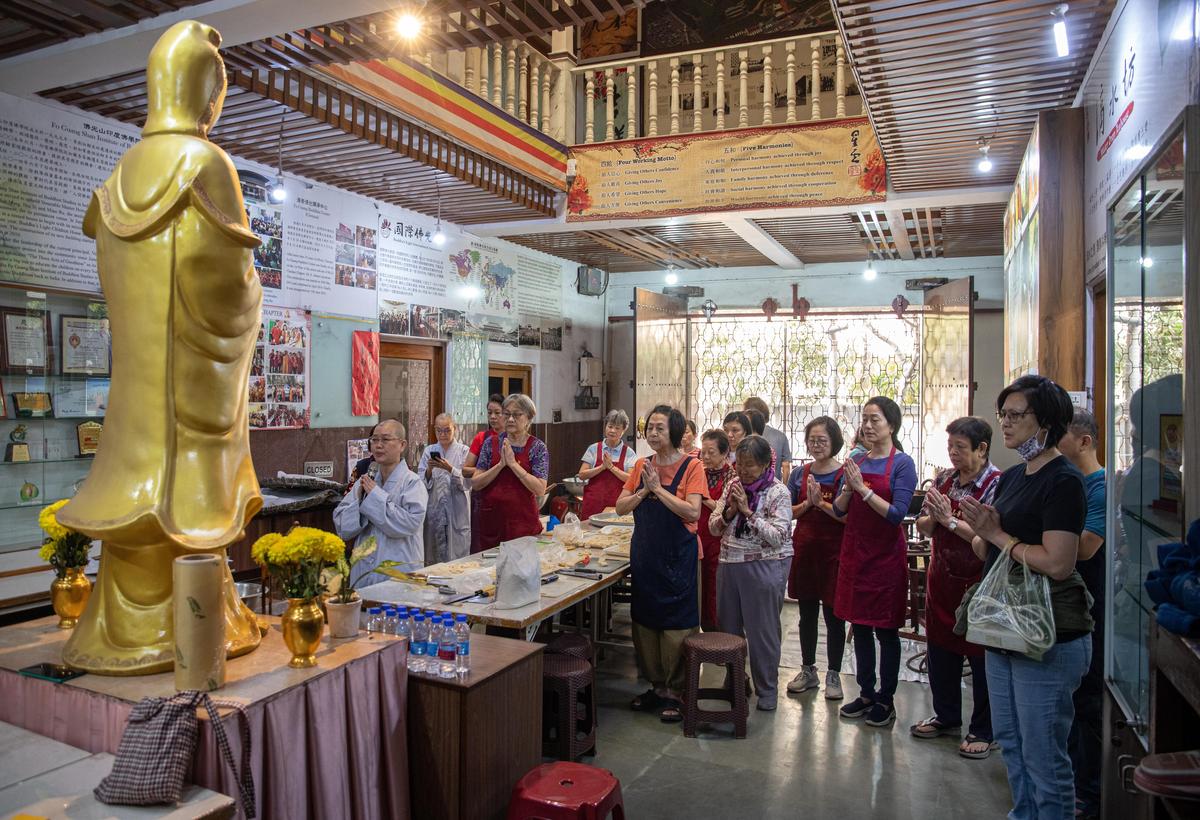  Chinese community members pray at the Fo Guang Shan Kolkata Buddhist Temple in Tangra, which they also use as a community space to make traditional food products for the Chinese New Year.