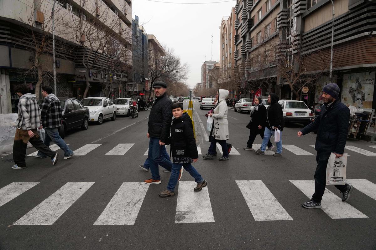 People cross an intersection in downtown Tehran, Iran, on January 15, 2026