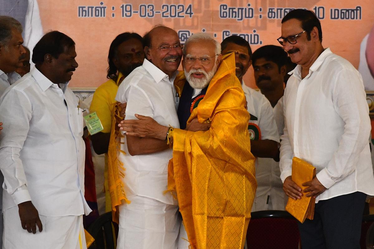 Prime Minister Narendra Modi and PMK founder S. Ramadoss greeting each other during the public meeting in Salem, on Tuesday, March 19 2024