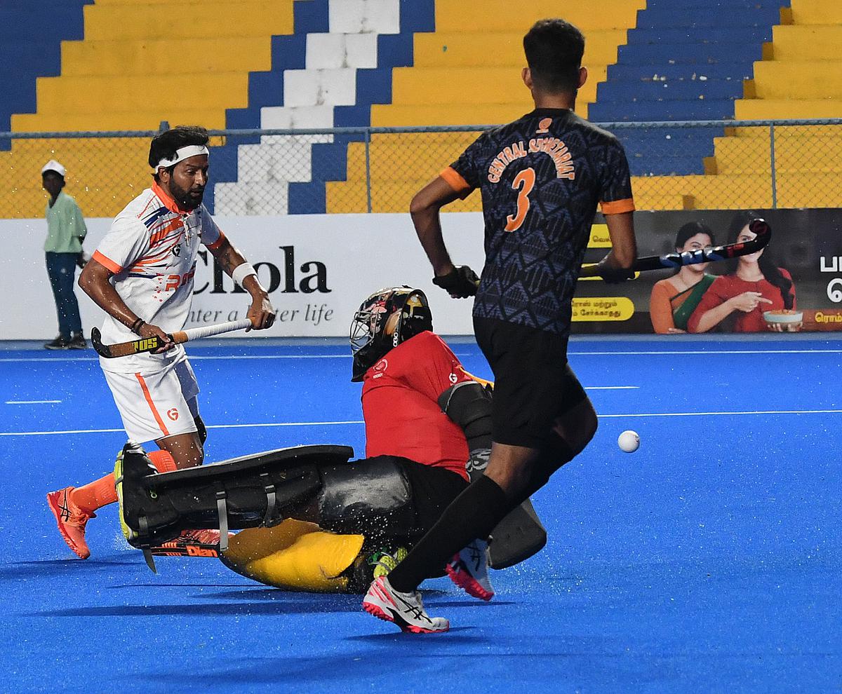 Indian Railways’ Yuvraj Walmiki, left, who scored four  goals, in action against Central Secretariat during the 94th All India MCC Murugappa Gold Cup Hockey Tournament on Thursday. 