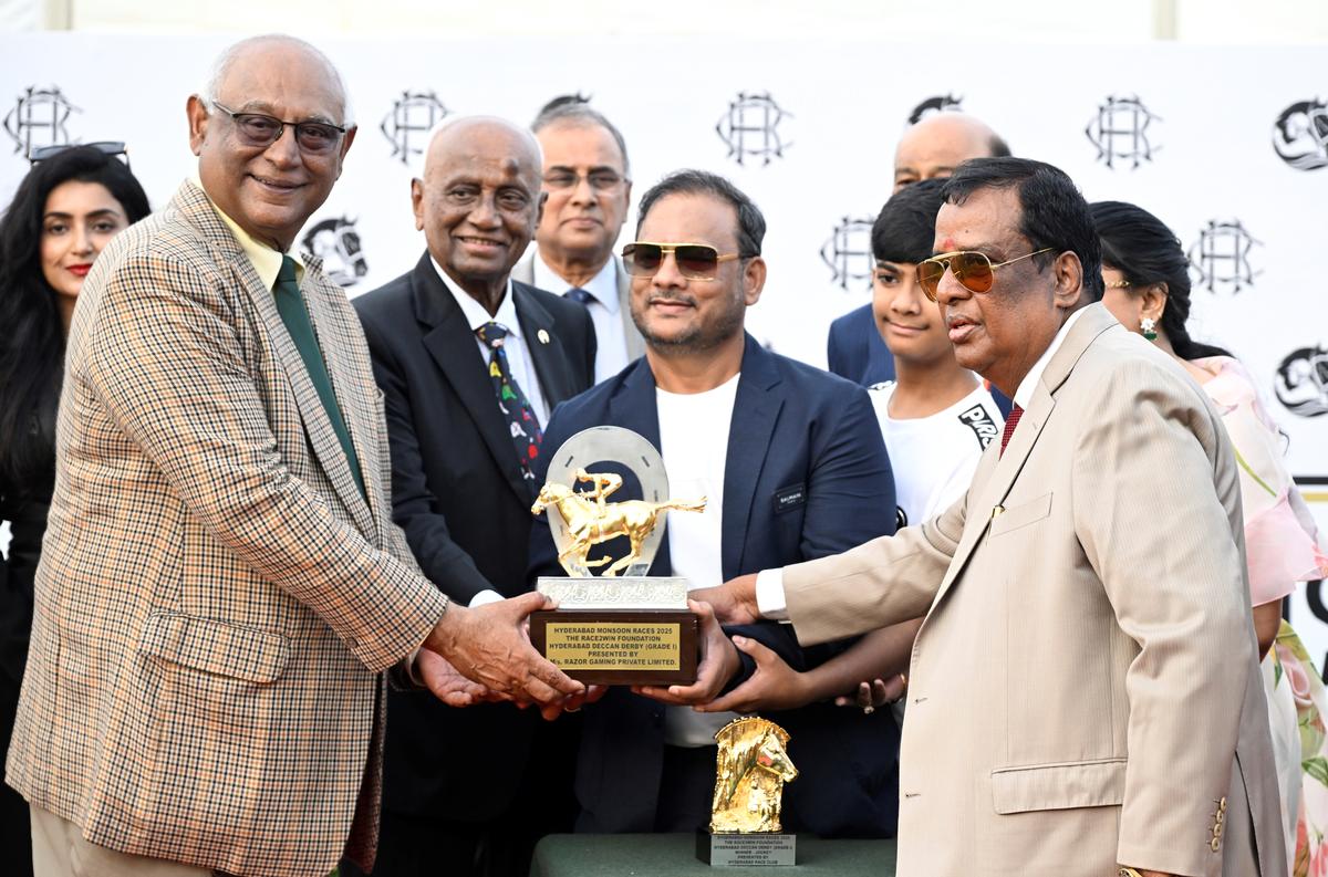 Y. Gopi Rao, founder of Race2win foundation, presenting the winner’s trophy to Mountain Jewel’s owners K. Kaliyaperumal and  Rajendran representing Rapar’s Galloping Stars LLP(L), in the presence of HRC chairman R.  Surender Reddy, in Hyderabad on Sunday. 