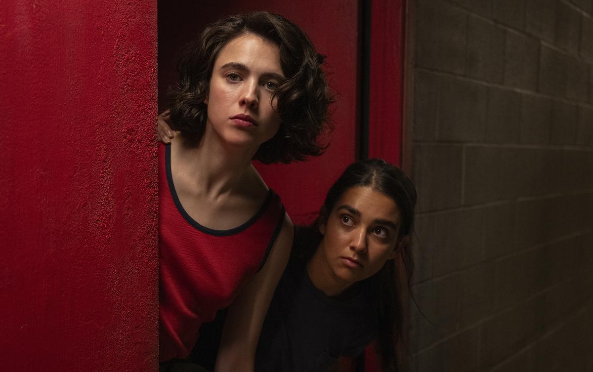 This image released by Focus Features shows Geraldine Viswanathan, right, and Margaret Qualley in a scene from ‘Drive-Away Girls’
