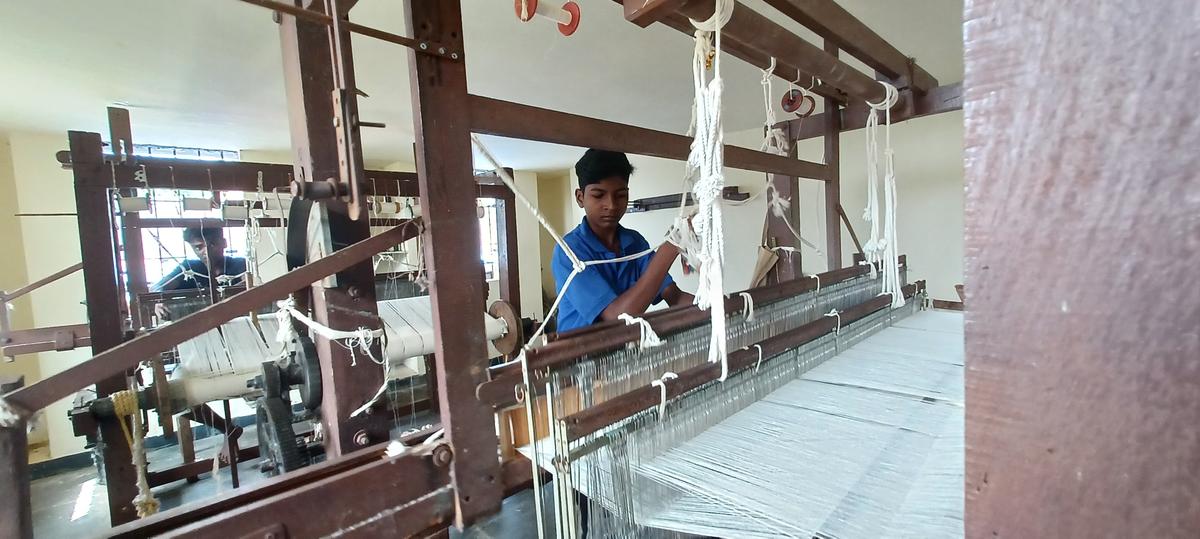A student of Jeevana Shaale near Melkote, learning traditional weaving skills.