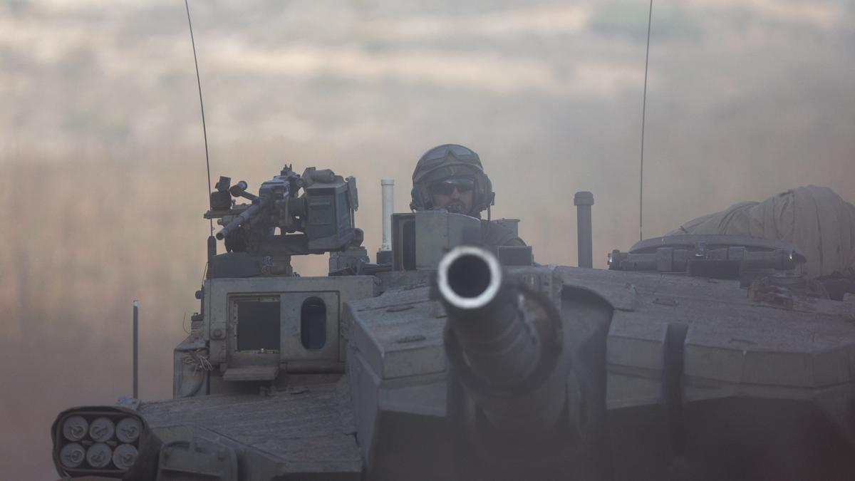 Israeli troops carry out an hour-long ground raid into Gaza before an expected wider incursion