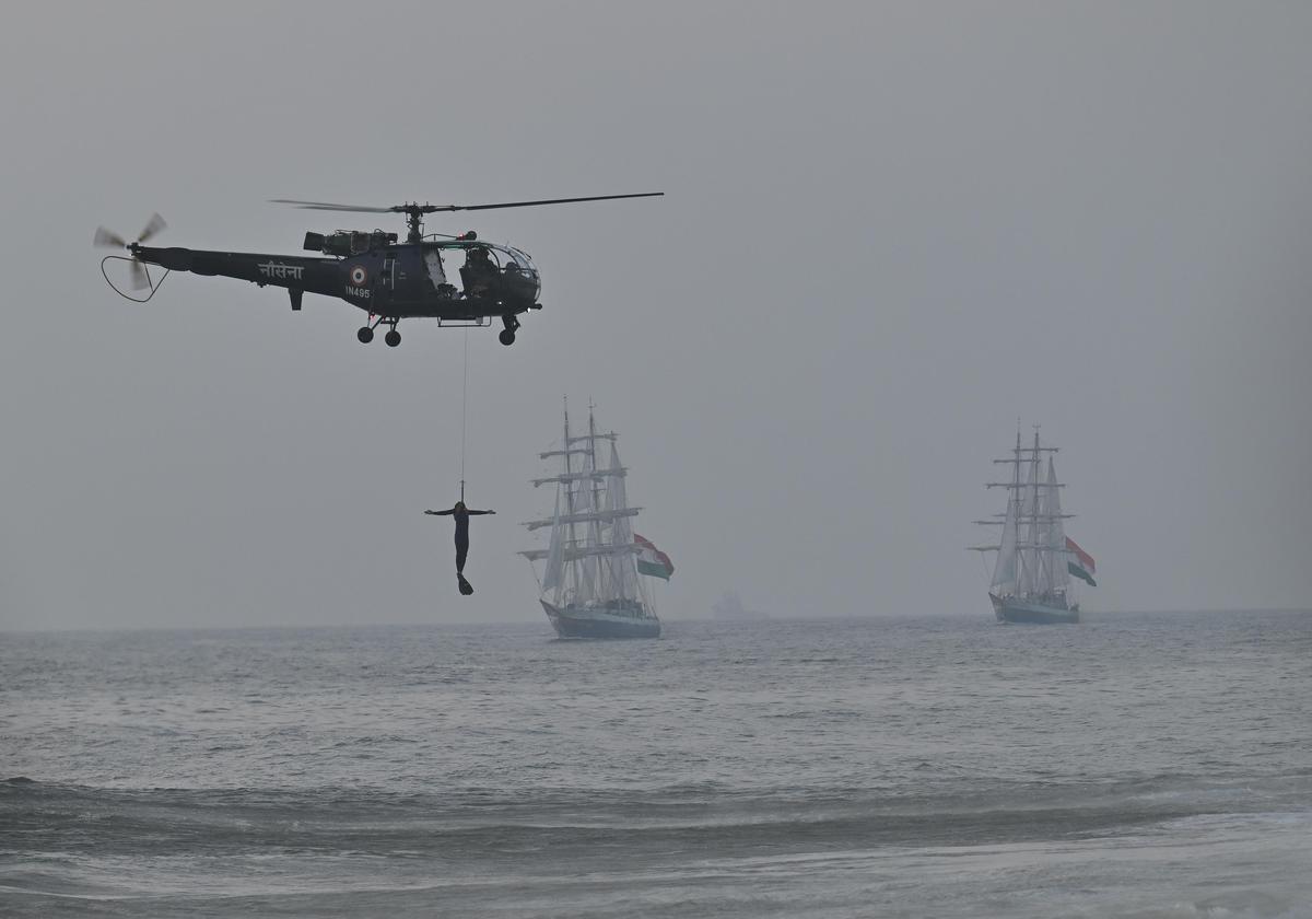 Indian Navy's Chetak helicopter performing rescue drill during Navy Day operational demonstration at Shanghumughom in Thiruvananthapuram on Wednesday. 