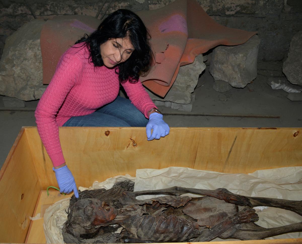 Cairo University radiologist Sahar Saleem is seen at the Egyptian Museum in Cairo with the “Screaming Woman” mummy, discovered in 1935 at Deir Elbahari near Luxor and dating to about 1500 BC during ancient Egypt’s New Kingdom period, in Cairo, Egypt, January 18, 2023 in this handout photograph released on August 2, 2024.