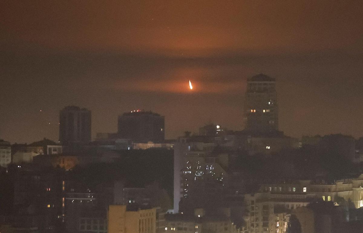 An explosion of a drone is seen in the sky over the city during a Russian missile and drone strike in Kyiv, Ukraine, on October 22, 2025.
