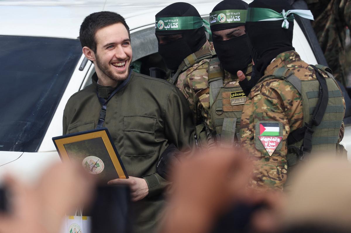 Omer Shem Tov, a hostage held in Gaza since the deadly October 7, 2023 attack, is escorted by Hamas militants as he is released as part of a ceasefire and a hostages-prisoners swap deal between Hamas and Israel, in Nuseirat, central Gaza Strip, February 22, 2025.