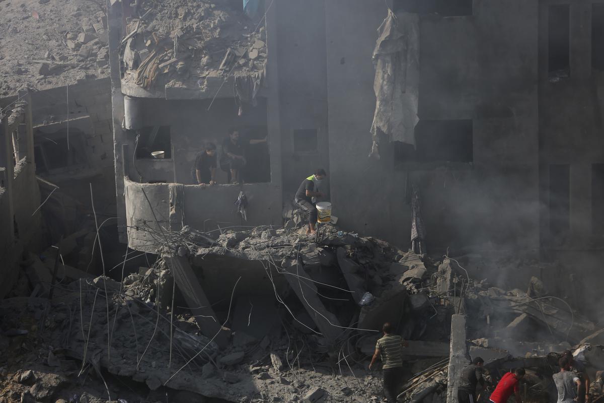 Palestinians look for survivors in the rubble of a destroyed building following an Israeli airstrike in Bureij refugee camp, Gaza Strip. File 