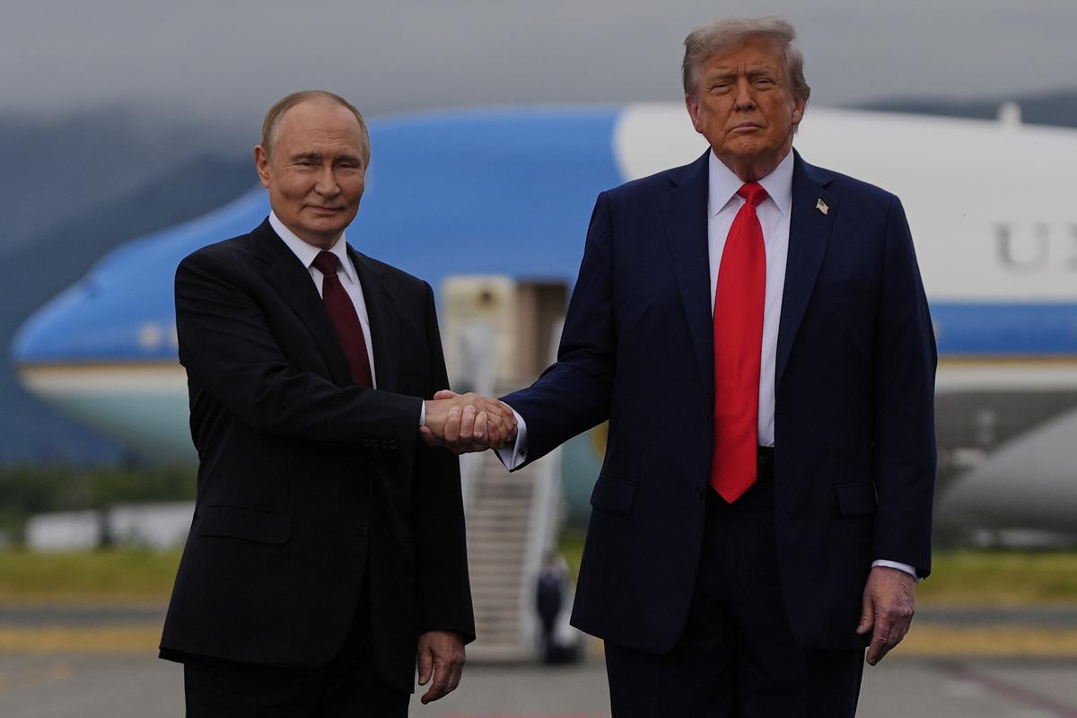 President Donald Trump greets Russia's President Vladimir Putin Friday, Aug. 15, 2025, at Joint Base Elmendorf-Richardson, Alaska. AP/PTI(AP08_16_2025_000003A)