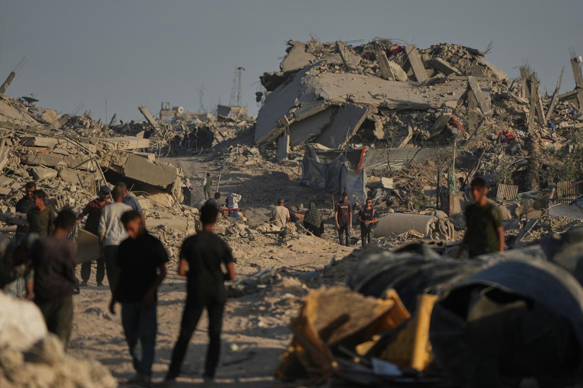 Displaced Palestinians inspect the remains of their destroyed homes in the heavily damaged Sheikh Radwan neighbourhood in Gaza City.