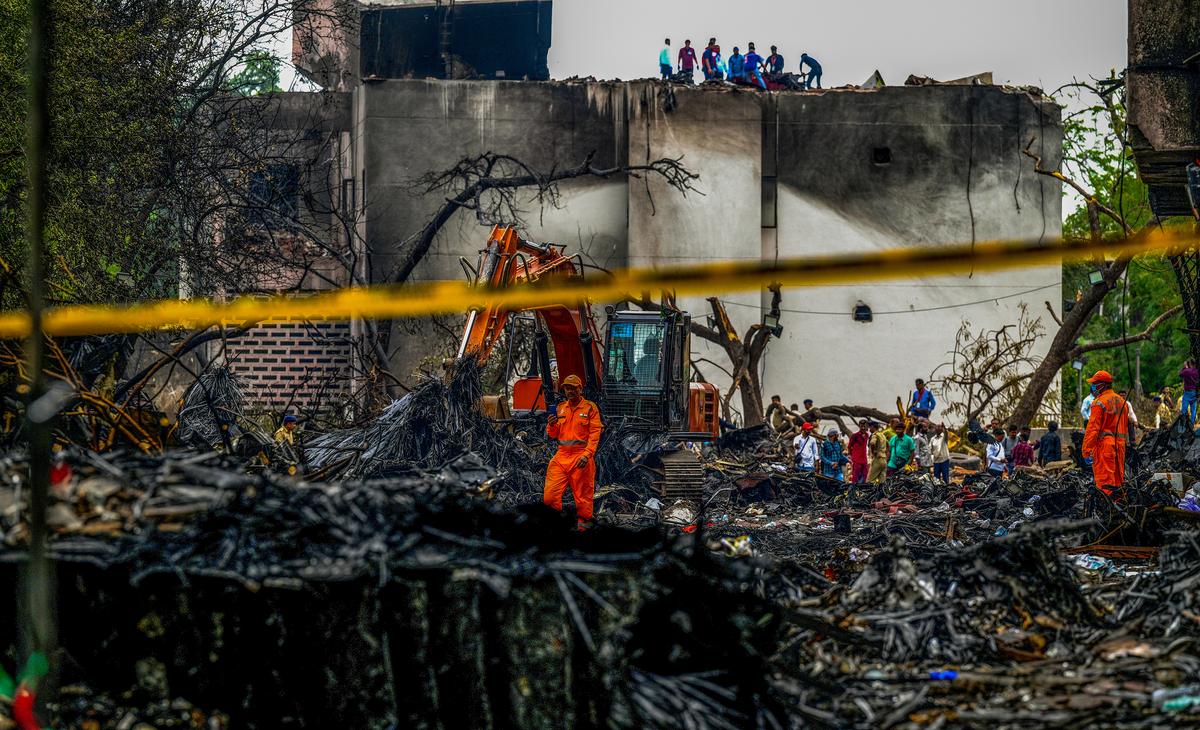 Workers amid the debris a day after the crash in Ahmedabad Workers amid the debris a day after the crash in Ahmedabad