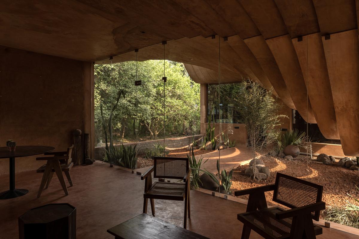 Living room and courtyard with curved ceiling.