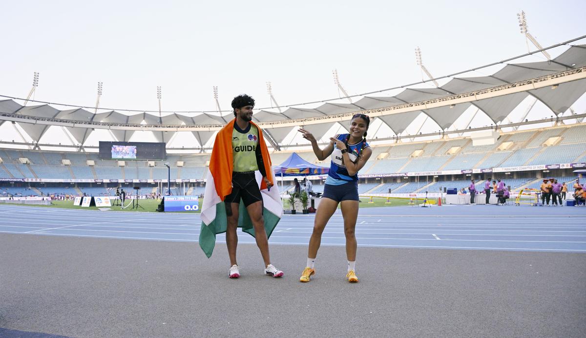 Simran Sharma with her guide Umar Saifi after coming second i in the women’s 200m T12 at the World Para Athletics Championships in New Delhi on Sunday.