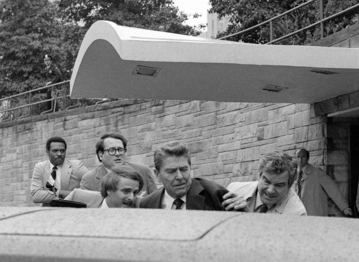  President Ronald Reagan waves and then looks up before being shoved into the President’s limousine by secret service agents after being shot outside a Washington hotel, March 30, 1981. The assassination attempt of former President Donald Trump has parallels to the last time a president or presidential candidate was wounded — in 1981 when Ronald Reagan was nearly killed by an assailant’s bullet. Reagan’s life was spared thanks to the quick actions of a Secret Service agent and the skill of doctors and nurses at a Washington, D.C., hospital. 