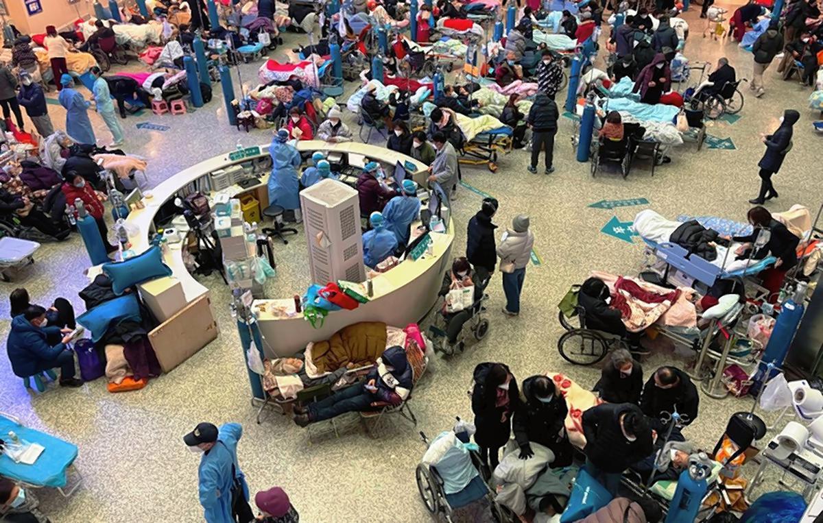 Patients with COVID symptoms crowd the halls of Changhai Hospital to receive medical treatment in Shanghai, China, January 3.