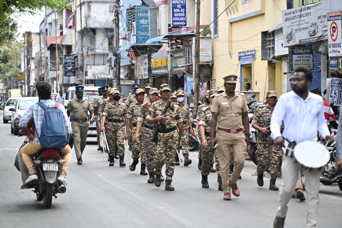 Police and CRPF personnel conduct a flag march in Chepauk-Thiruvallikeni Assembly constituency on Wednesday