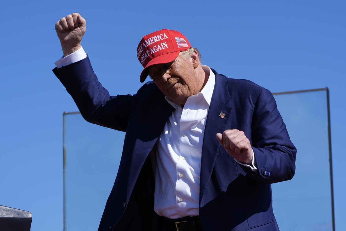 President Donald Trump dances after speaking at a campaign rally at Wilmington International Airport