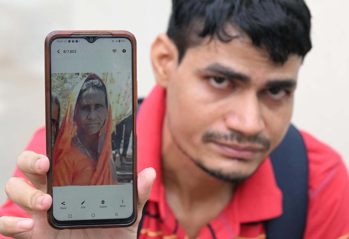Pappu Singh of Bharatpur shows a picture of his mother, who is missing after the stampede. 