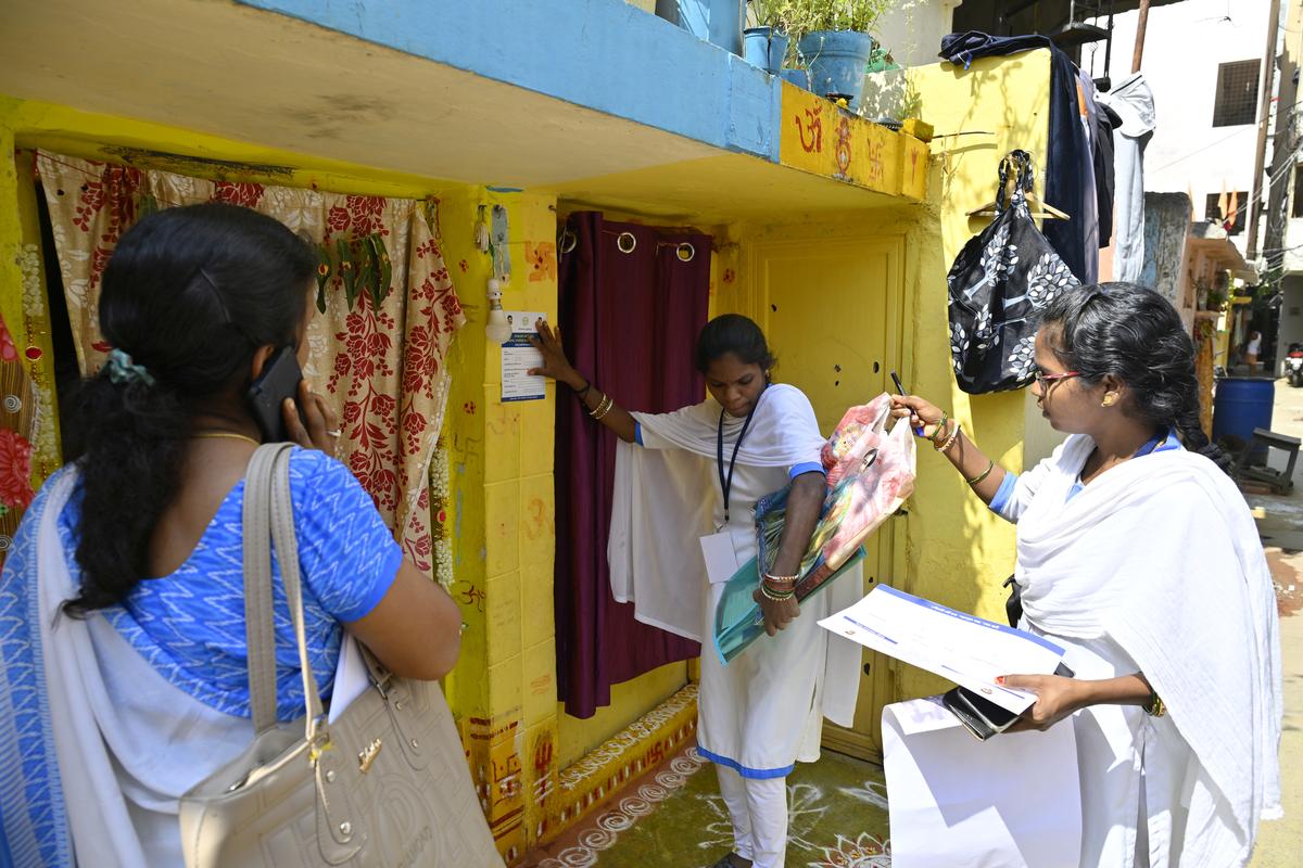 Enumerators affixing stickers to houses allotted to them for the Socio, Economic, Caste, Education and Political survey being conducted by Telangana government, in Hyderabad on Wednesday(November 6, 2024).