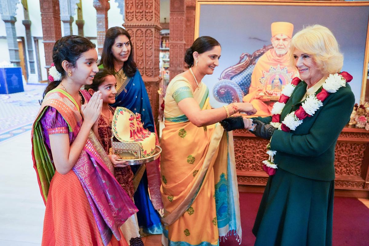 Britain's Queen Camilla receives a bracelet as she and King Charles III visit the BAPS Shri Swaminarayan Mandir Britain's Queen Camilla receives a bracelet as she and King Charles III visit the BAPS Shri Swaminarayan Mandir
