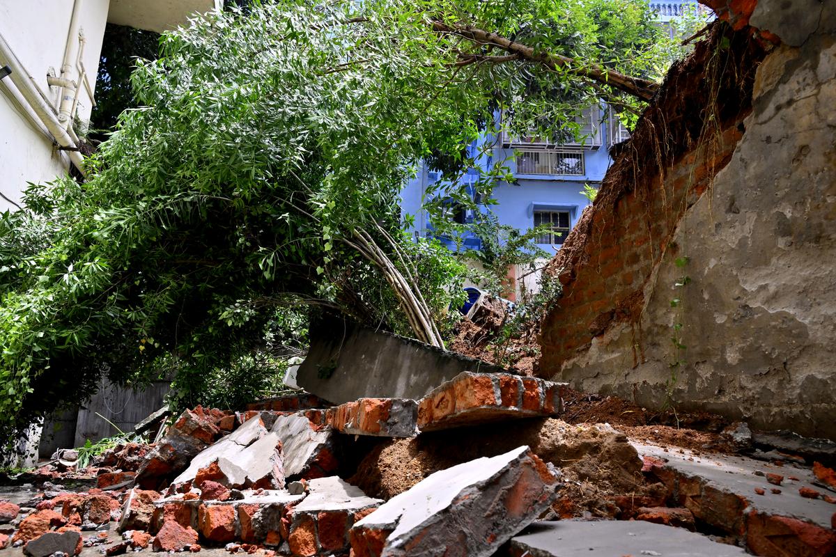 Compound wall of an apartment complex collapsed at Punjagutta due to lightning strike during heavy rain in the early hours of Tuesday in Hyderabad. 