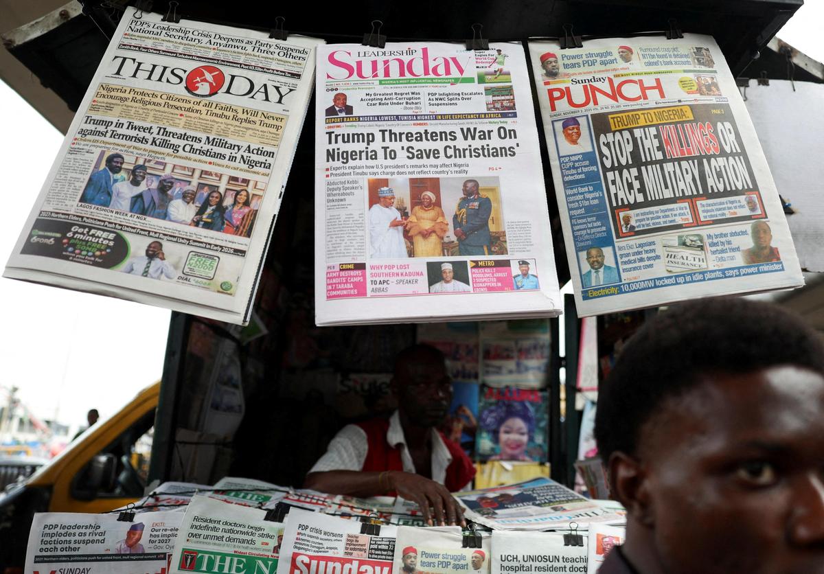 Newspapers with articles reporting U.S. President Donald Trump's message to Nigeria over the treatment of Christians hang at a newspaper stand in Ojuelegba, Lagos, Nigeria on November 2, 2025
