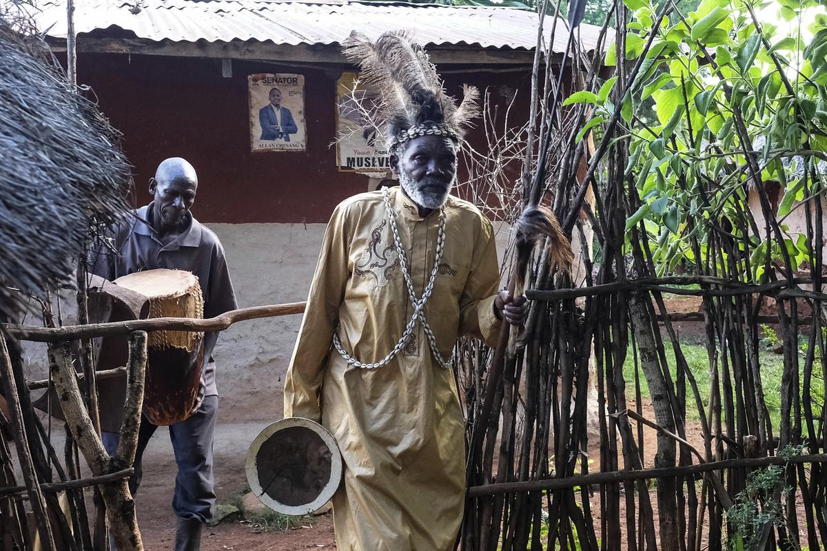 Seer Atukung Tafala, front, walks inside his igloo-like shrine in Mbale, Uganda, Saturday, June 21, 2025. Seer Atukung Tafala, front, walks inside his igloo-like shrine in Mbale, Uganda, Saturday, June 21, 2025.