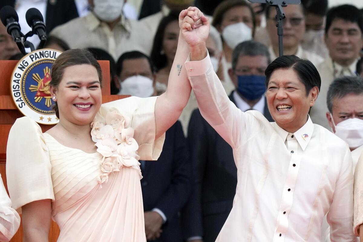 Philippine President Ferdinand Marcos Jr., center right, and Vice President Sara Duterte, daughter of former Philippine President Rodrigo Duterte, raise hands during the inauguration ceremony at National Museum on Thursday, June 30, 2022 in Manila, Philippines.