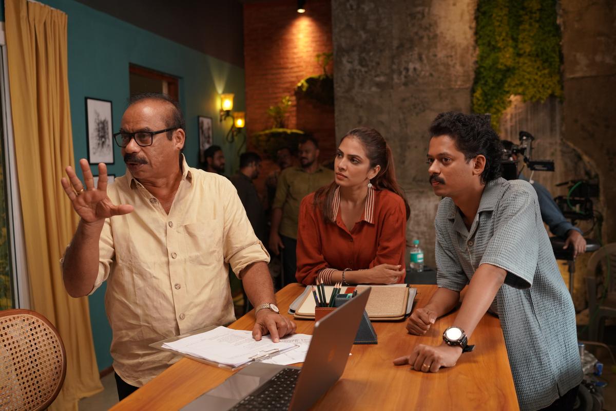 Sathyan Anthikad with Malavika Mohanam and Sangeeth Prathap on the sets of the film.