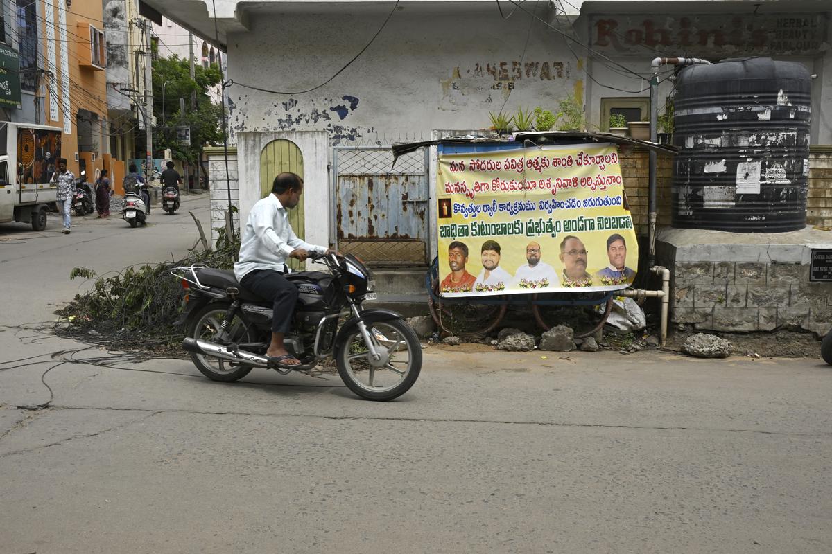 A man rides past a condolence poster of the five men electrocuted when their chariot touched a sagging high-tension wire during the Krishna Janmashtami procession in Hyderabad’s Ramanthapur on August 17 night. A man rides past a condolence poster of the five men electrocuted when their chariot touched a sagging high-tension wire during the Krishna Janmashtami procession in Hyderabad’s Ramanthapur on August 17 night.