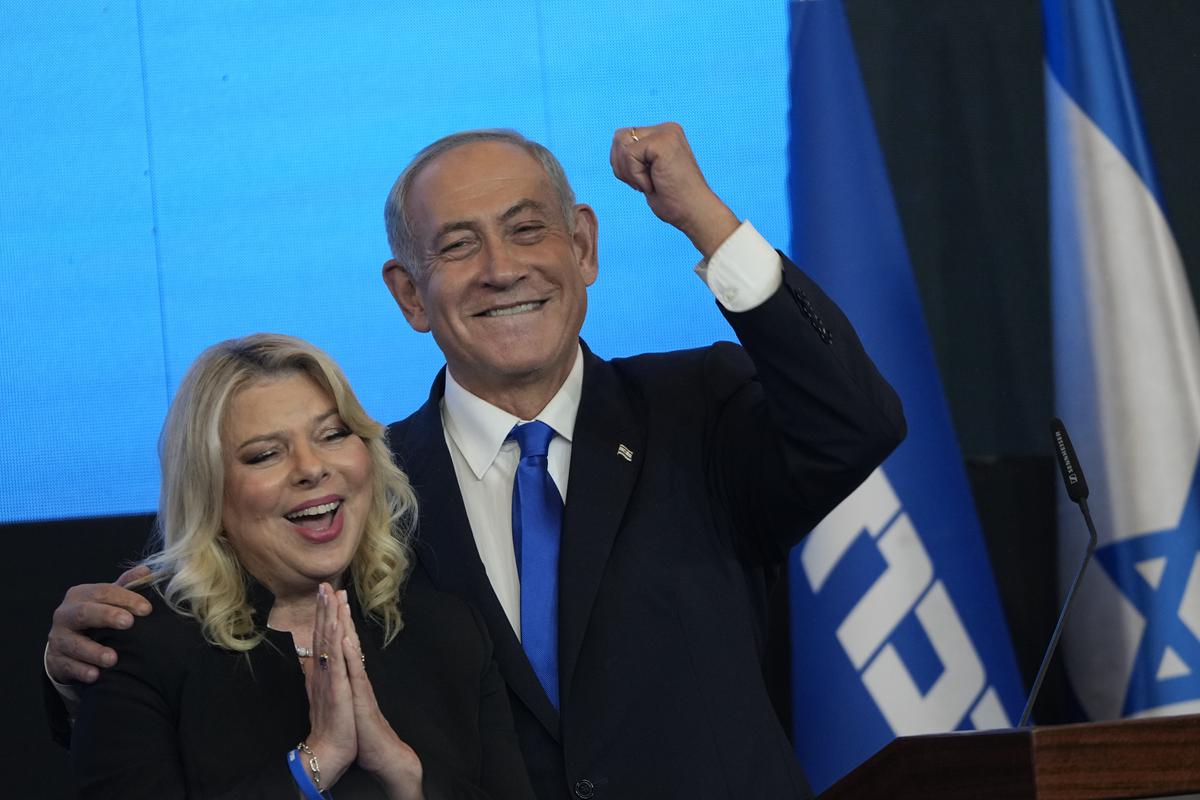 Former Israeli Prime Minister and the head of Likud party, Benjamin Netanyahu and his wife Sara gesture after first exit poll results for the Israeli Parliamentary election at his party’s headquarters in Jerusalem. 