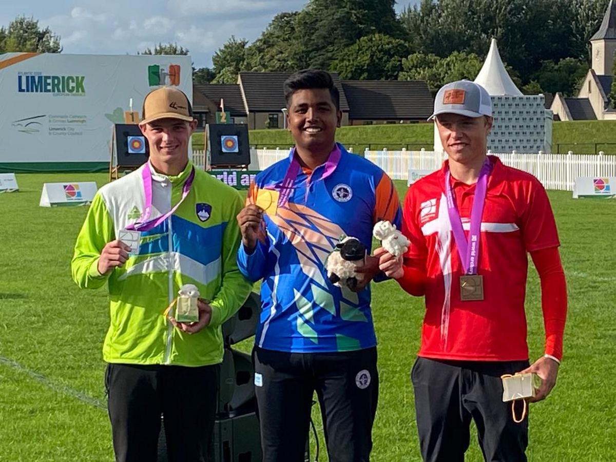 Calm amid the storm: Priyansh (centre) relied on his cool temperament to overcome the windy conditions and corner glory in the under-21 men’s compound category.| Photo credit: PTI