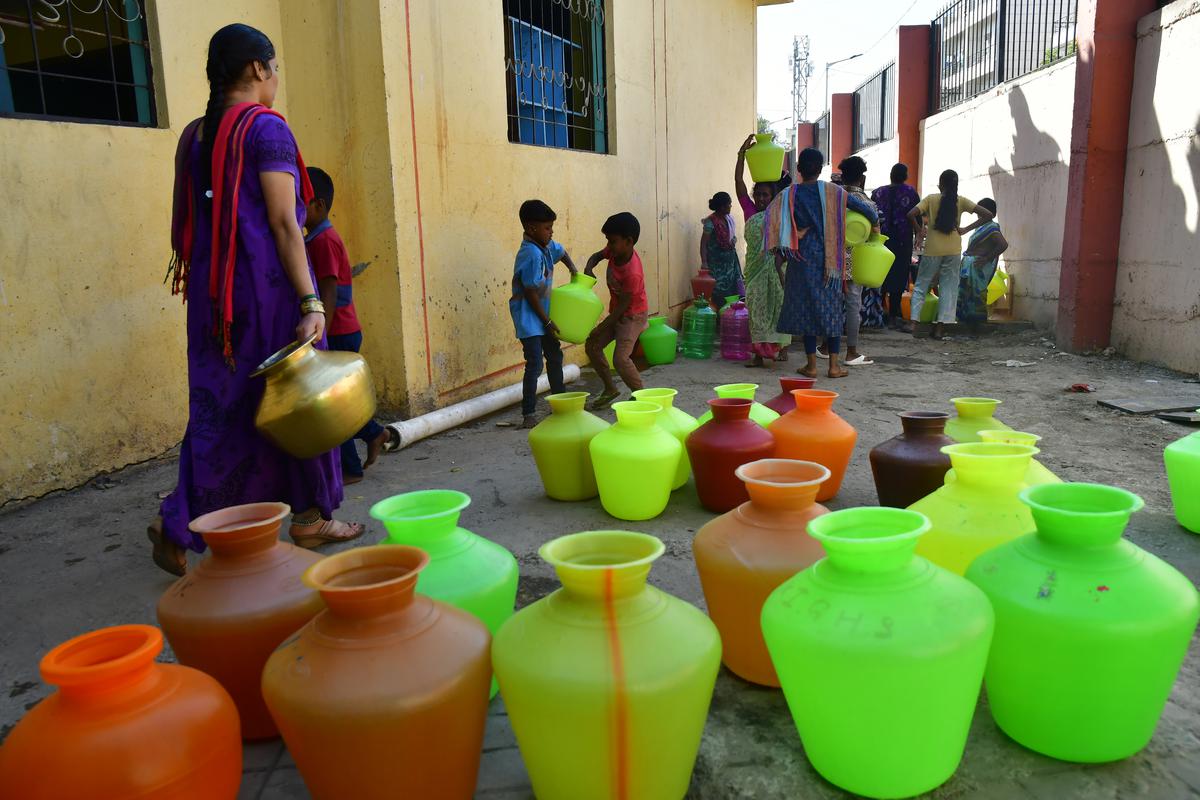 Women and children collect potable drinking water from a public tap at Nayandahalli off Mysuru road, in Bengaluru. The water is supplied by the Bangalore Water Supply and Sewerage Board.  