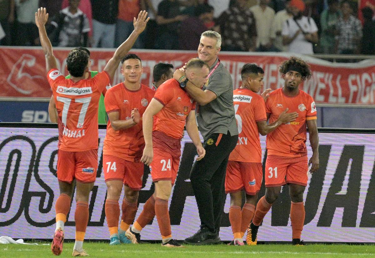 PFC players and coach Dilmperis celebrate their second goal against Hyderabad.