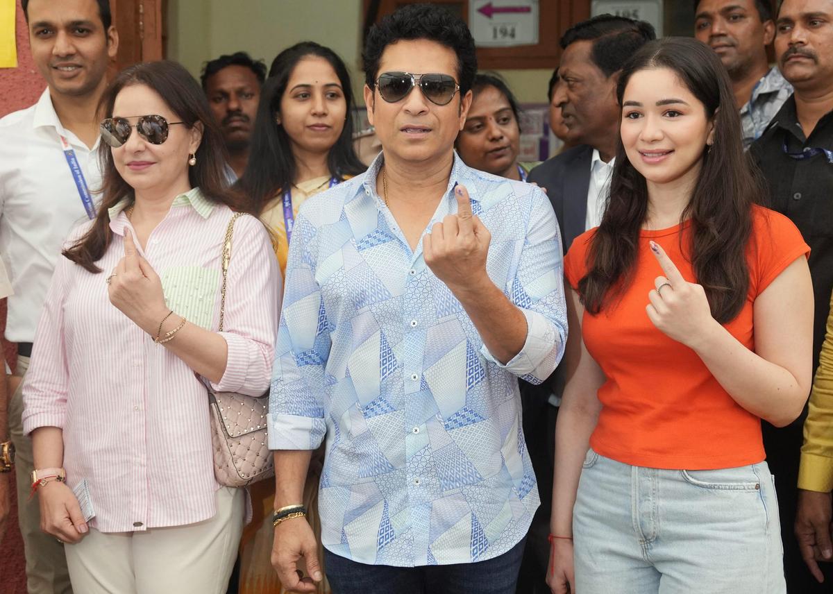 Mumbai: Former cricketer Sachin Tendulkar, wife Anjali and daughter Sara show their fingers marked with indelible ink after casting votes at a polling station during the Maharashtra Assembly elections, in Mumbai