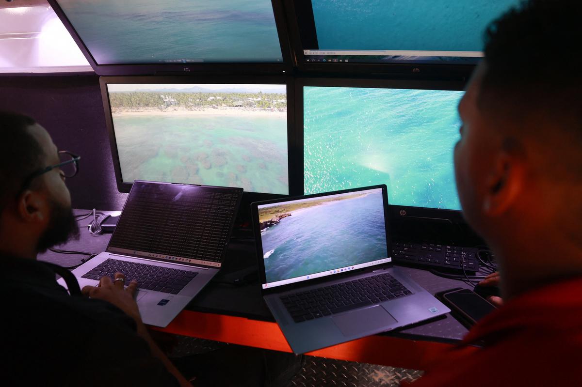 Members of the Armed Forces of the Dominican Republic observe images transmitted by drones as part of the ongoing search operation of Sudiksha Chowdary Konanki  in Punta Cana, Dominican Republic on March 13, 2025.
